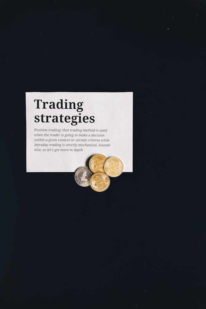 A minimalist image featuring trading strategies text and coins on a black background, ideal for finance concepts.